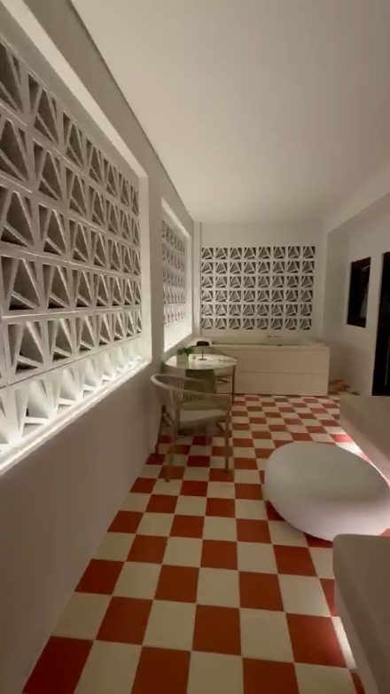 The living space with its checkerboard floor, lattice screens and jacuzzi