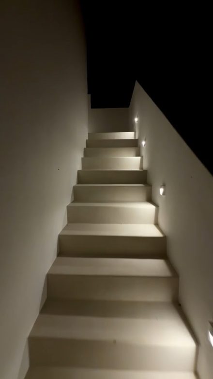 The lit stone stairway of the house at night
